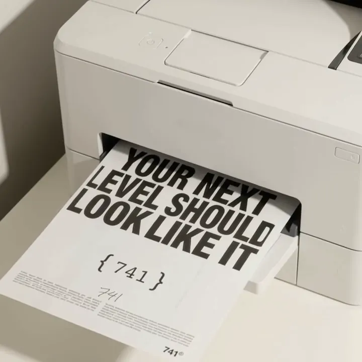 741 brand print piece emerging from a printer