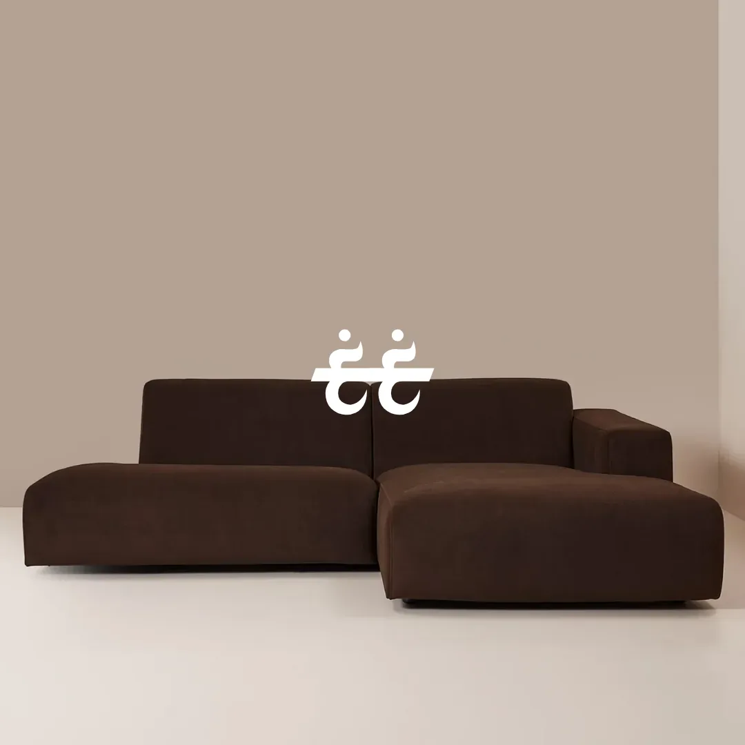 White Arabic-inspired mark above a brown modular sofa in a warm neutral room